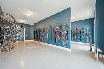 A room with bikes hanging on a blue wall